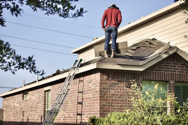 Professional roofer working on a residential roof in Allenspark